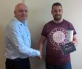 Neil Bennett congratulating Nathan Lloyd on achieving 10 years at Optima